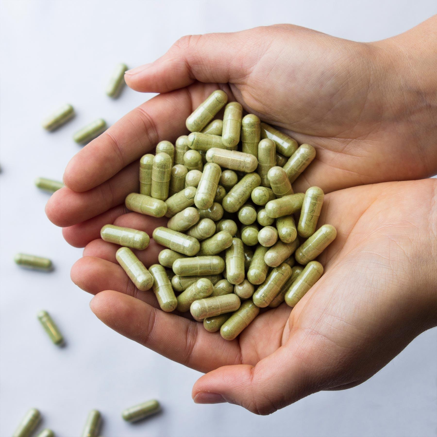 Kapseln, Pillen, Grüne Kapseln, Vitaminenhüllen, Handvoll